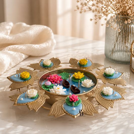 Floating urli candle tray with gold leaf petals and multicolor flower candles on table