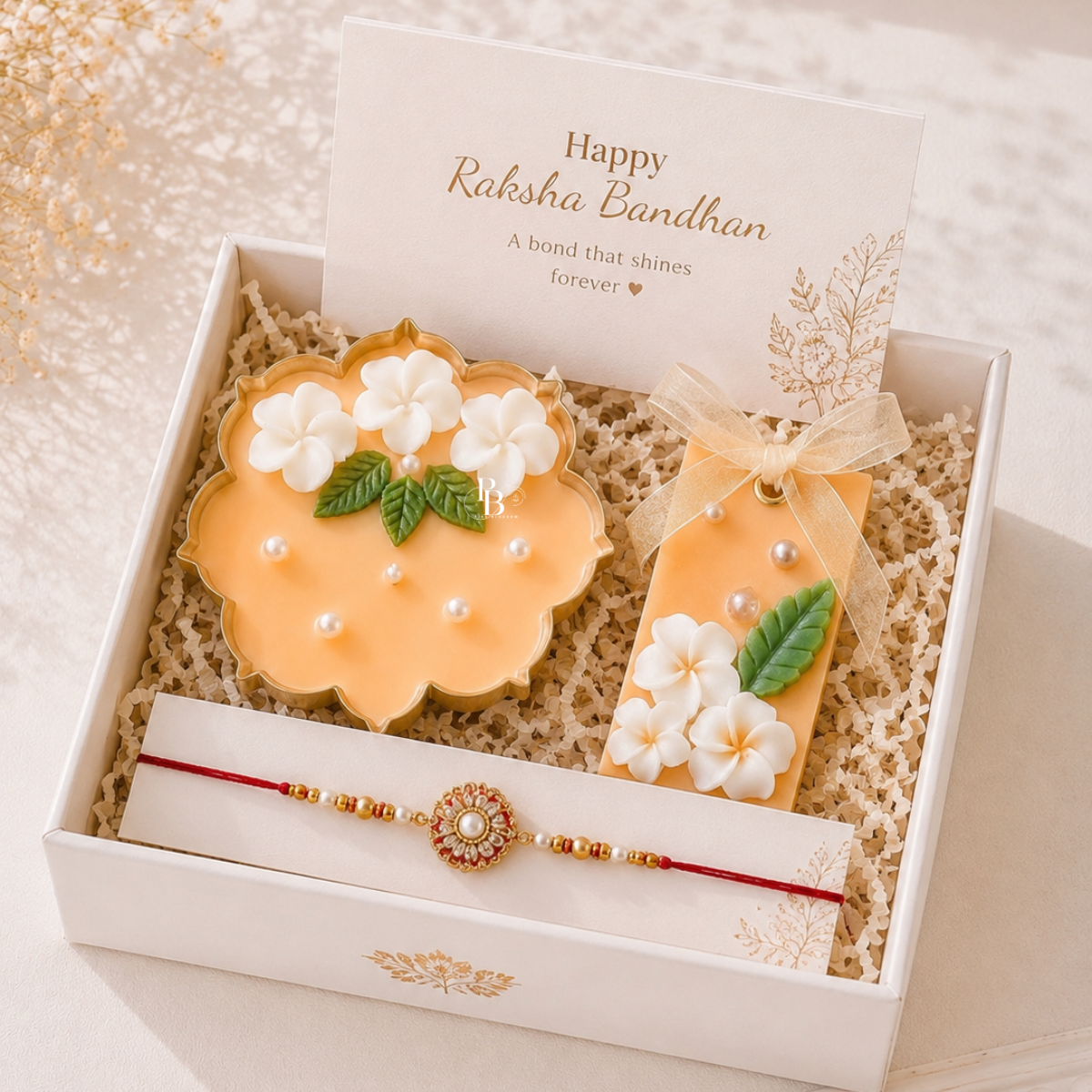 Pearl Blossom™ Luxury Raksha Bandhan Gift Hamper | Handcrafted Floral Soy Wax Candle, Aroma Sachet & Designer Rakhi