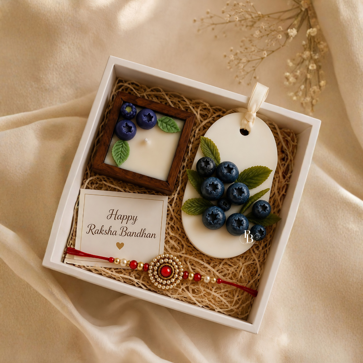 Luxury Raksha Bandhan gift set with blue berry candle and beaded rakhi bracelet