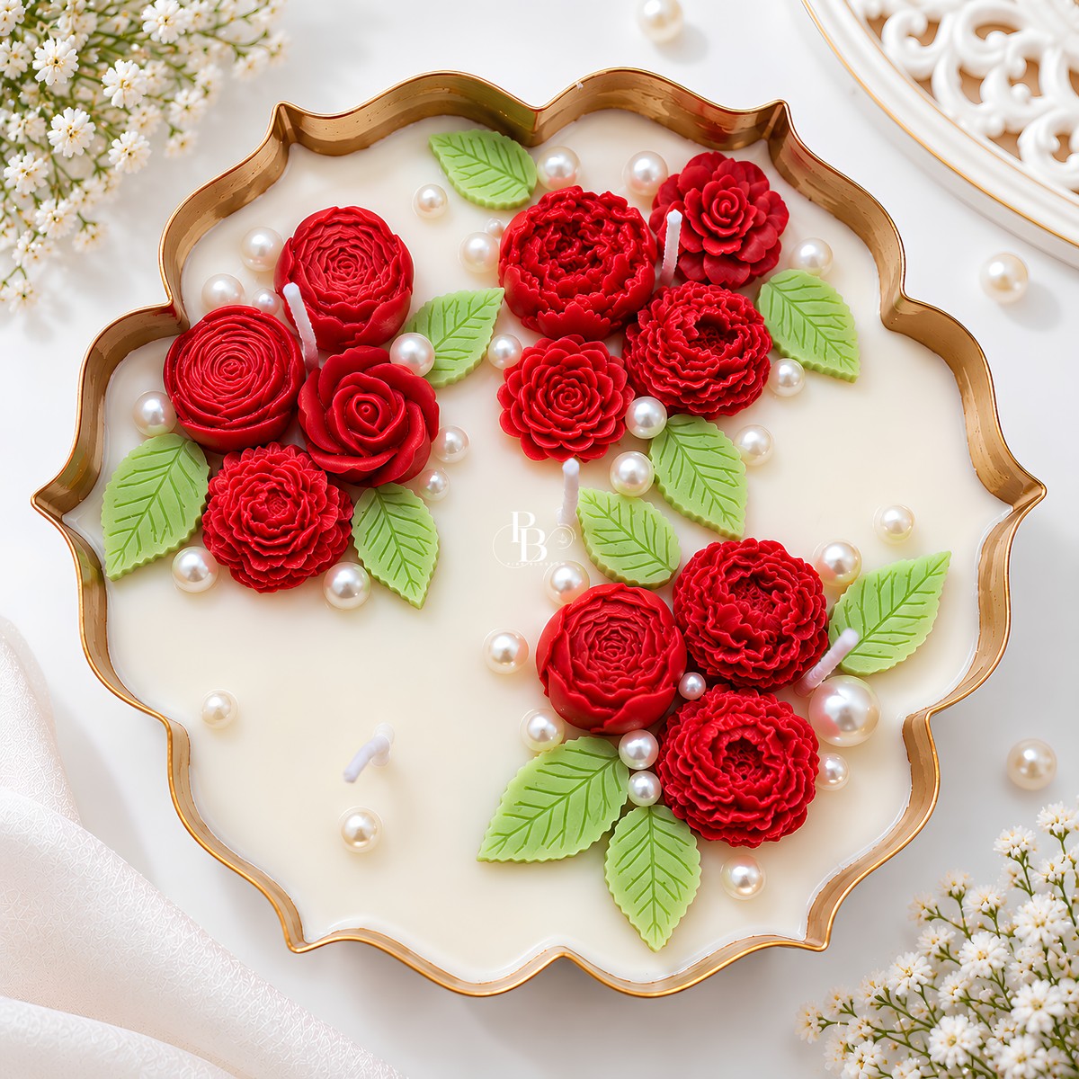 Rouge Éternelle™ candle with red rose-shaped wax flowers, green leaves, and pearl accents