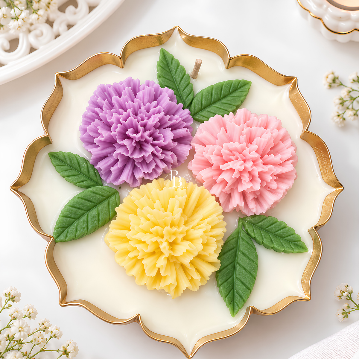 Decorative floral wax candle with pink, purple, and yellow flower shapes in gold-rim bowl