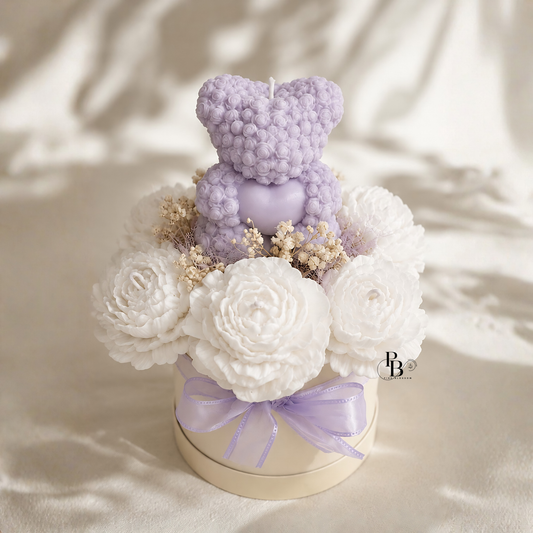 Lilac Teddy Bloom™ candle bouquet with lilac teddy candle, white rose candles, ribbon