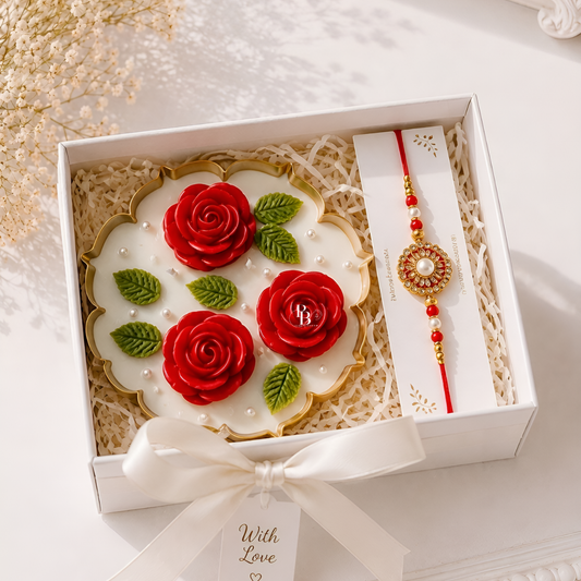 Gift hamper box with red rose soy wax candle and red-gold designer rakhi with beads