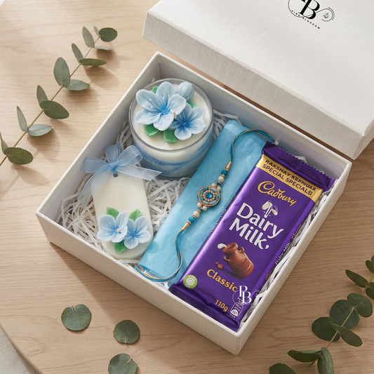 Luxury Raksha bandhan gift box with blue floral candle, rakhi bracelet, and Dairy Milk chocolate