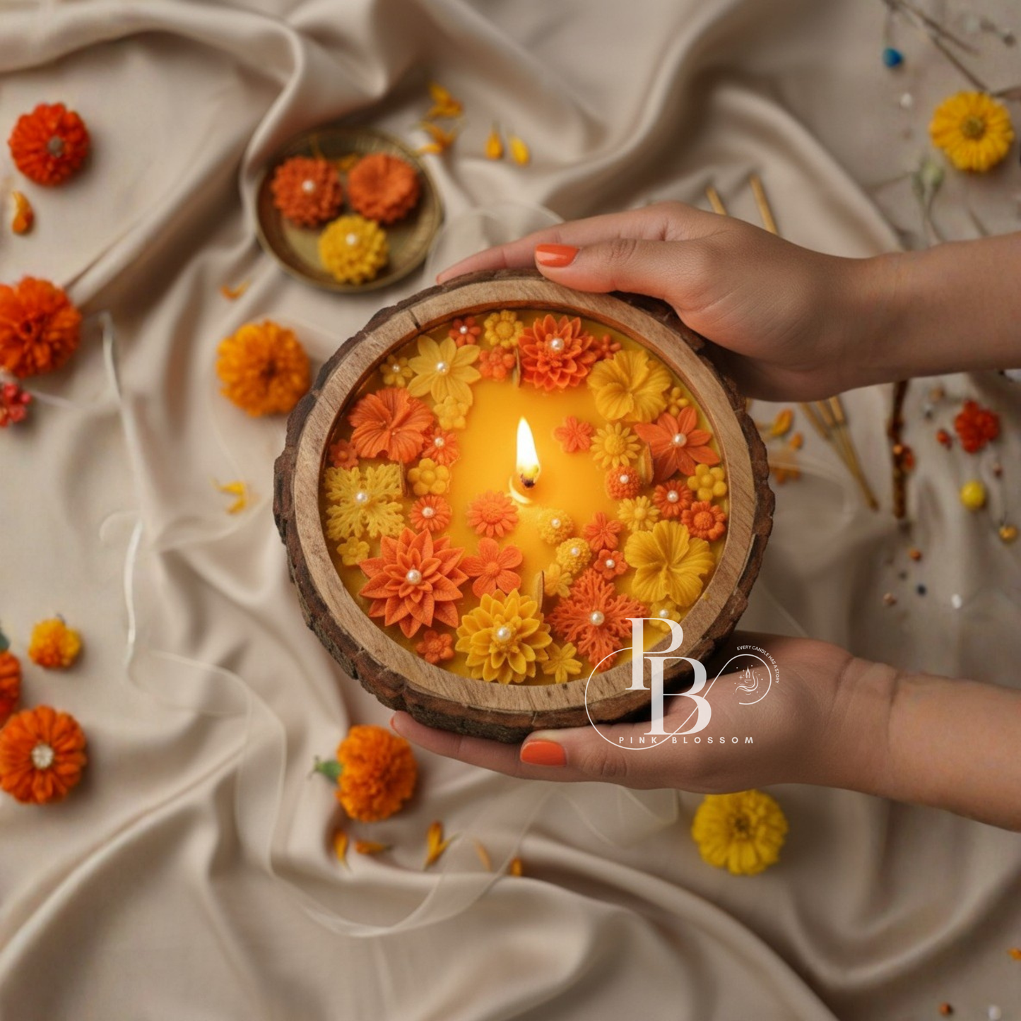 Orange and yellow floral soy wax candle in round wooden base, lit wick center