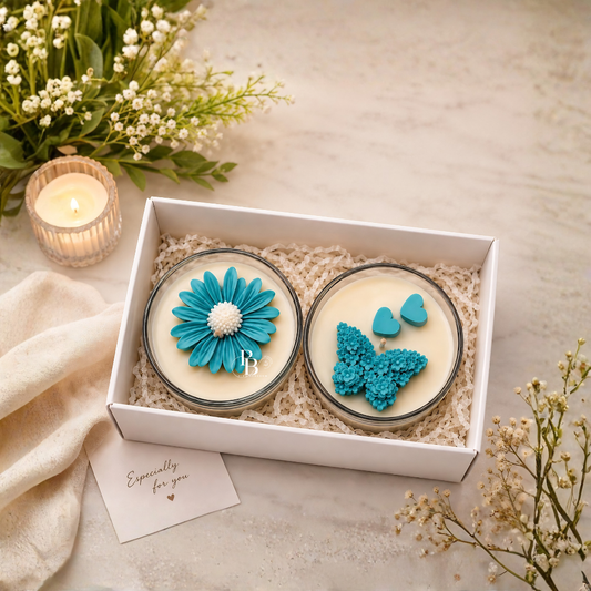 Luxury gift hamper with two round blue floral candles in open white box