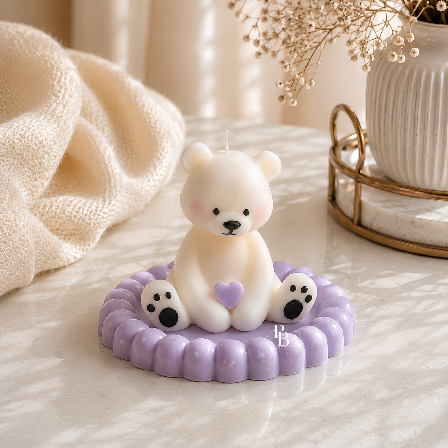 Lavender teddy bear soy wax candle with heart, seated on ruffled wax base