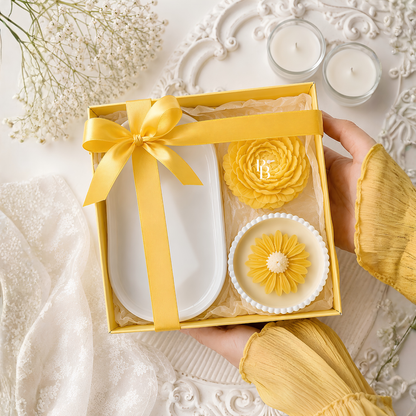 Luxury candle gift hamper with yellow ribbon, white and yellow flower-style candles