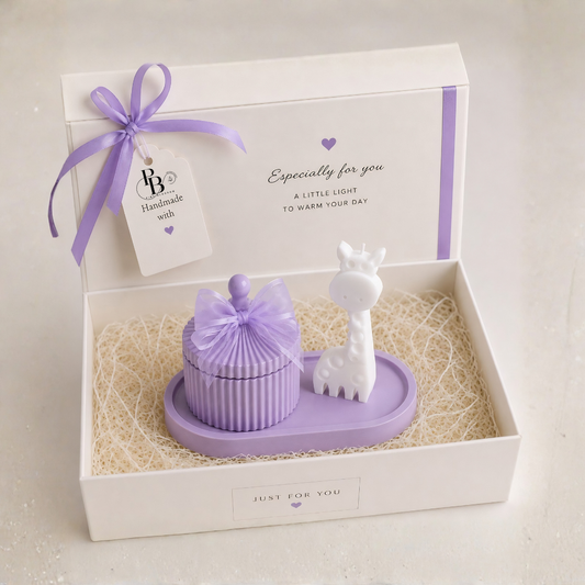 Lavender gift hamper set in open box with ribbon bow, ribbed candle and white animal figurine