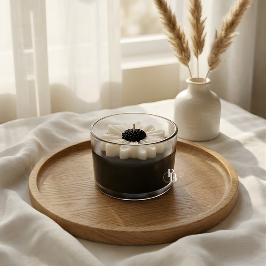 Soy wax candle in dark glass jar with white daisy top and black center