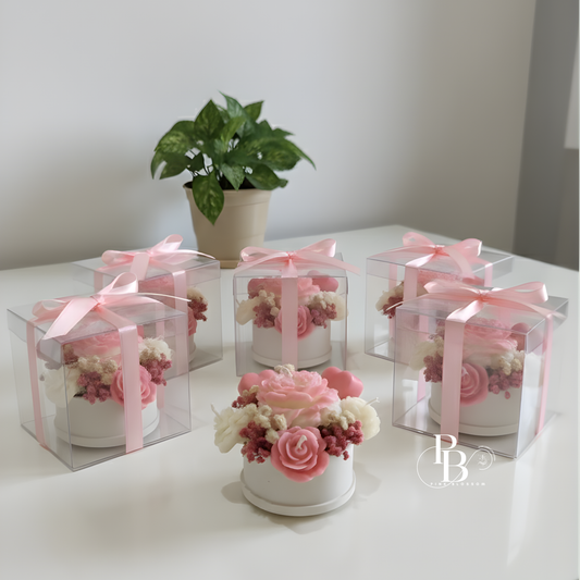 Floral candle bouquet set: three clear boxes with pink ribbon and small pink-rose candles