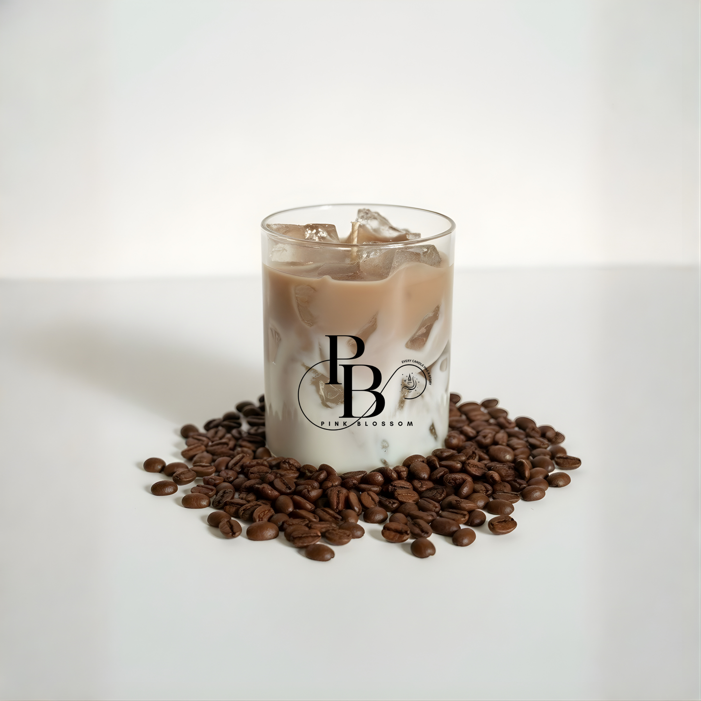 Coffee-scent candle in clear glass with tan wax and floating wax pieces