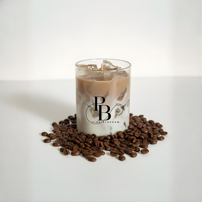 Coffee-scent candle in clear glass with tan wax and floating wax pieces