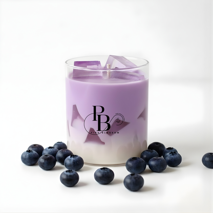 Lavender candle in clear glass with purple wax and blueberry accents