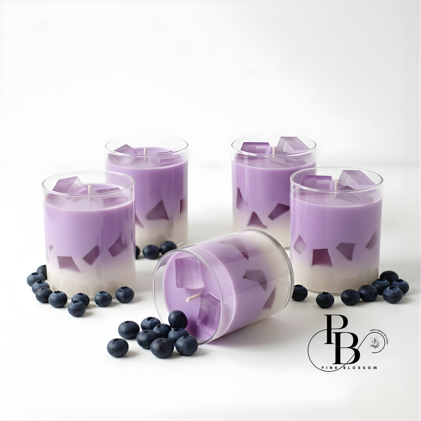 Purple candle set in clear glass with lavender wax and blueberry accents