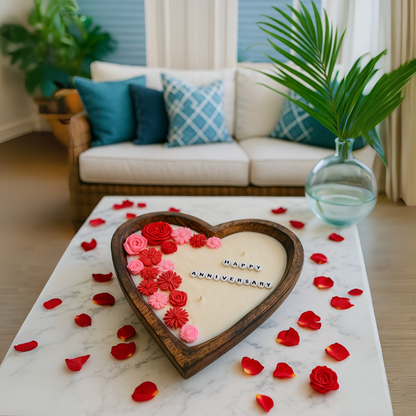 Heart-shaped floral candle with roses, “Happy Anniversary” on white wax