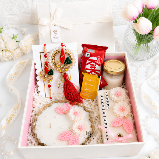 Blush & Bond luxury Raksha Bandhan hamper with rakhi, flowers, sweets, jar