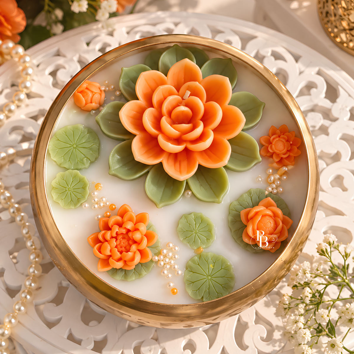 Floral candle with gold rim and orange flower lid design
