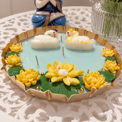 Candle set in gold tray with blue wax, two snowman candles, yellow flowers and beads