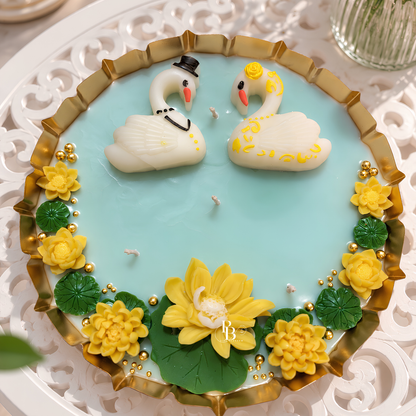 Blue wax candle set in gold tray with two snowman candles, central yellow flower and gold beads