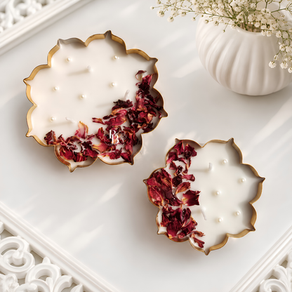 Scalloped gold-rim candle with white wax, pearl studs, and dried rose petals