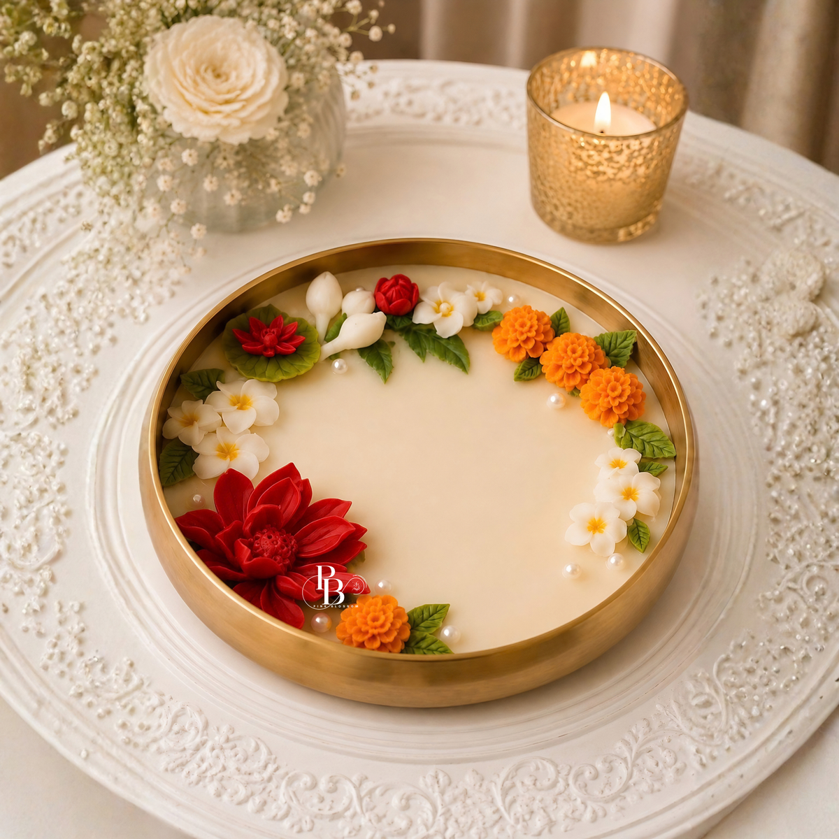 Lit decorative floral candle with gold holder and embedded flower ring on wax