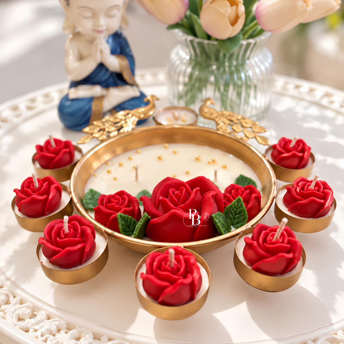 Rubis Paon Royale™ candle with gold rim tray and red rose petals on white wax center